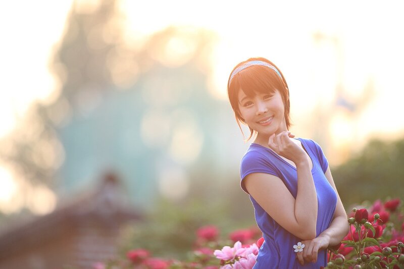 woman in blue dress smiling