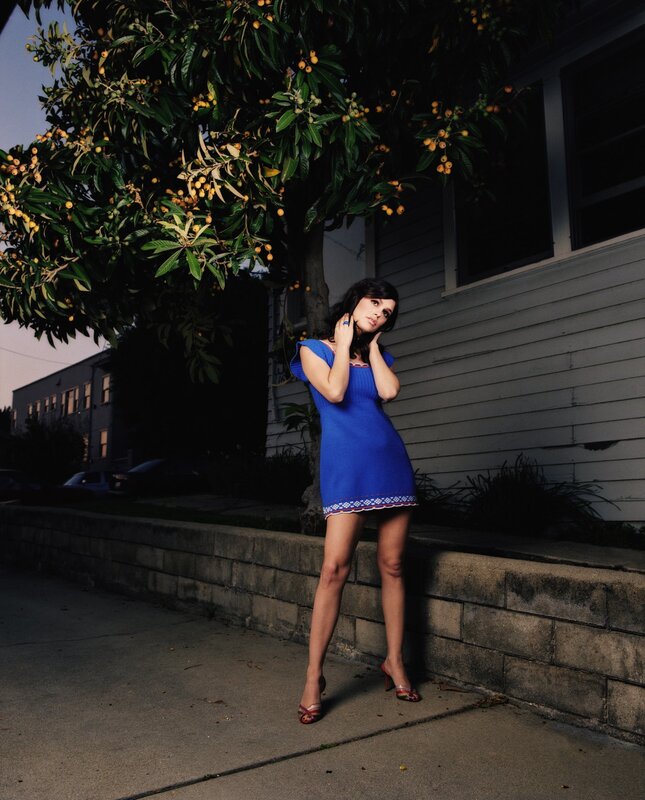 Woman in blue dress under tree