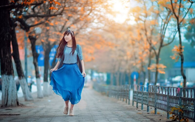 Woman in blue dress walking