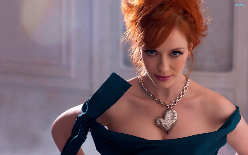 Woman in blue dress with heart necklace