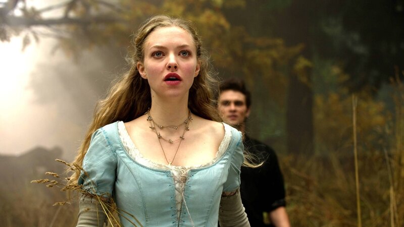 woman in blue dress with man behind