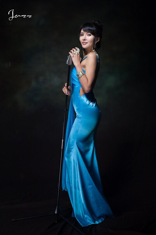 woman in blue dress with microphone