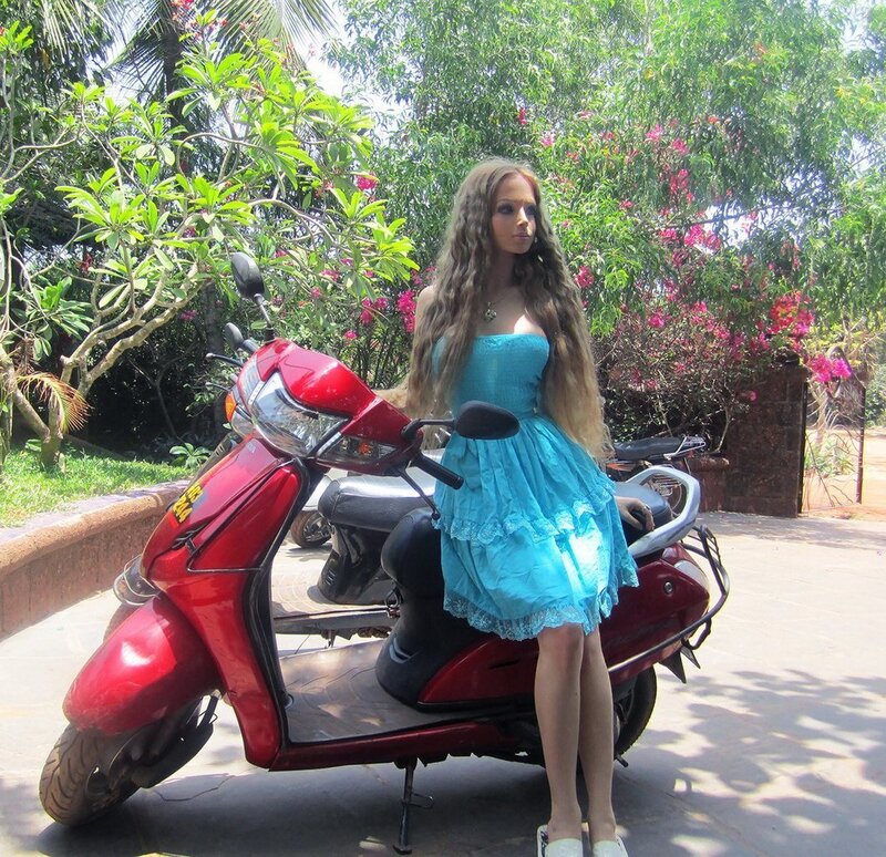 Woman in blue dress with scooter