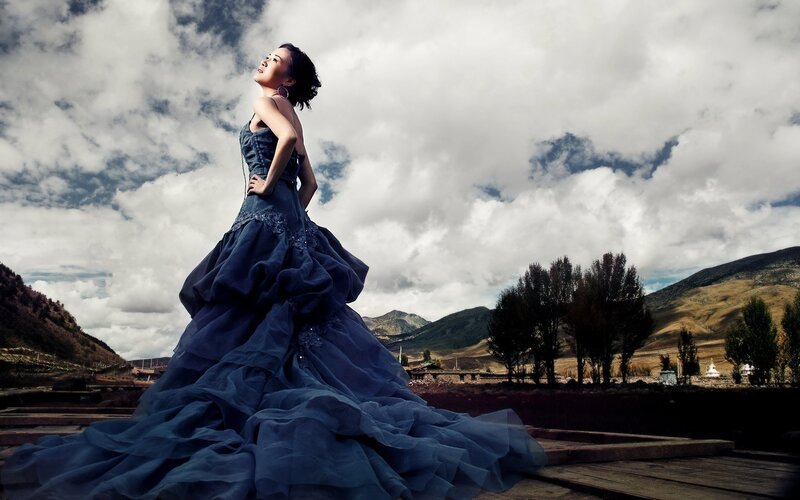 Woman in blue gown on mountain path