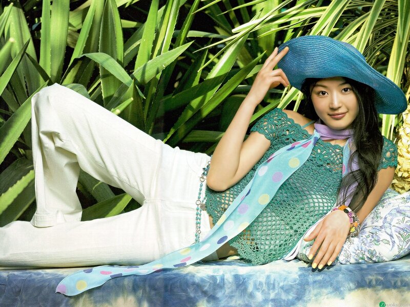woman in blue hat and green top