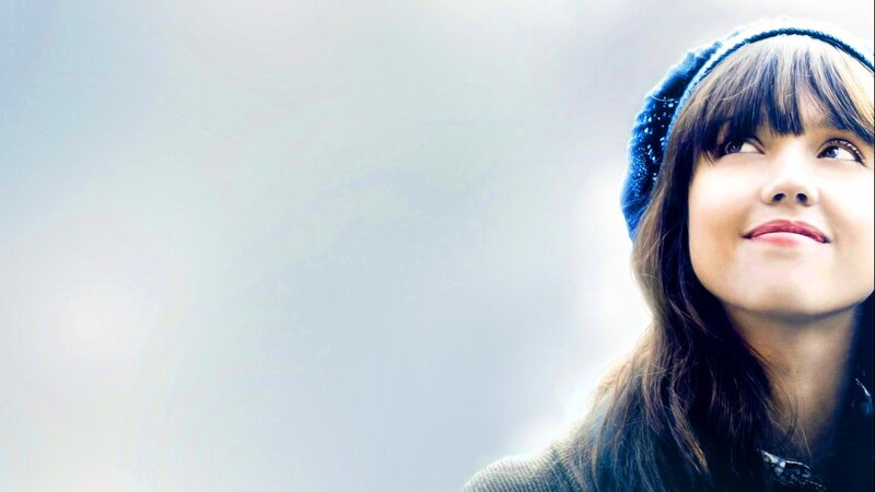 woman in blue hat looking up