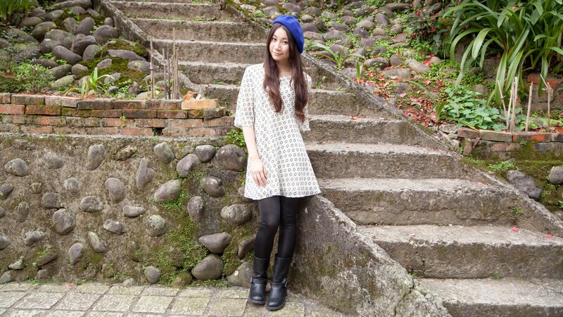 Woman in blue hat on stone steps