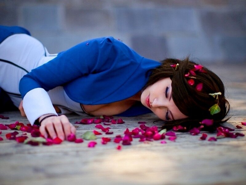 woman in blue jacket lying on ground