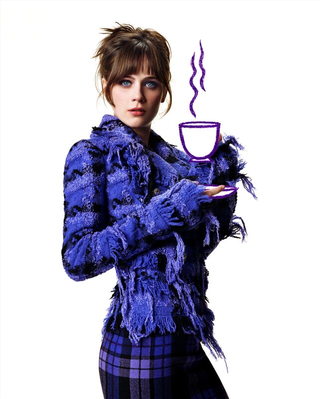 Woman in blue jacket with coffee cup