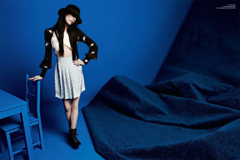woman in blue room with hat