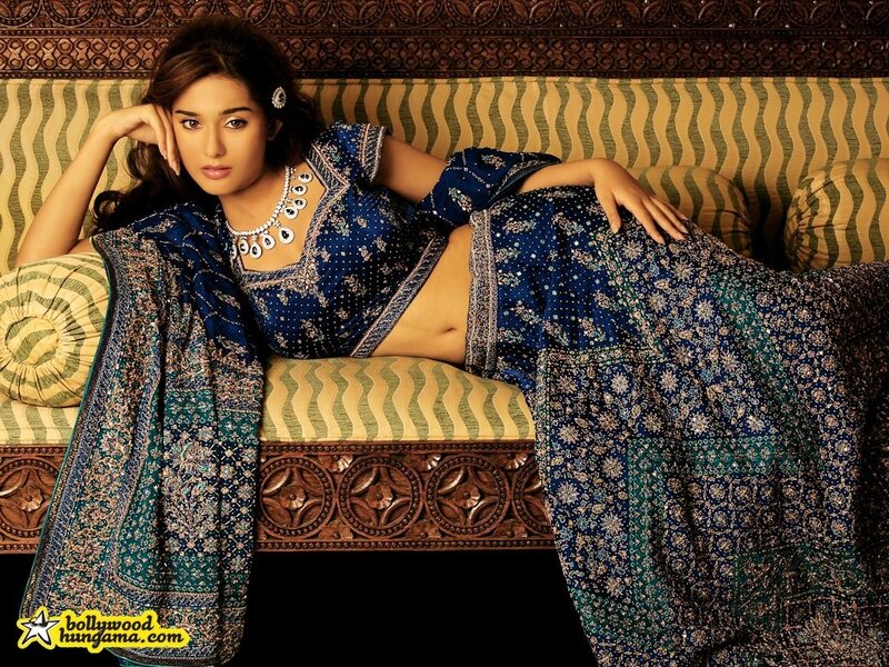 woman in blue sari on sofa