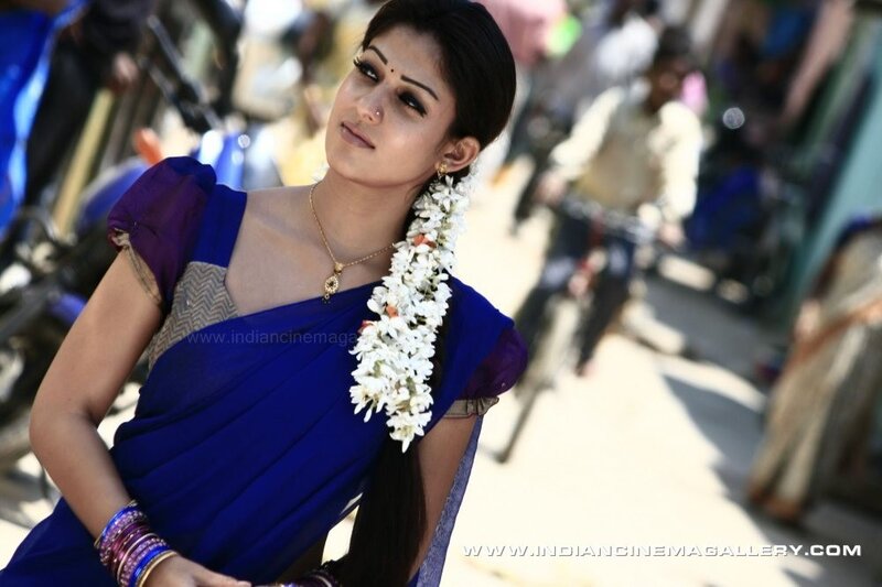woman in blue sari with flower garland