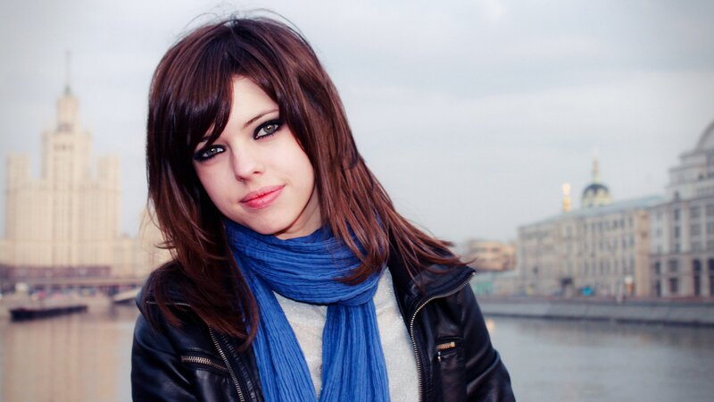 woman in blue scarf by river