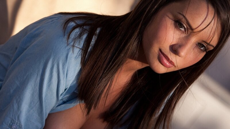 woman in blue shirt looking at camera