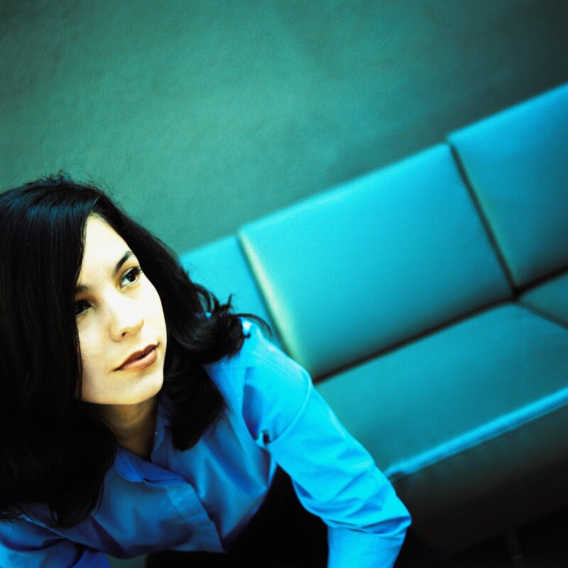 woman in blue shirt on couch