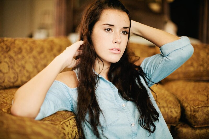 woman in blue shirt on couch