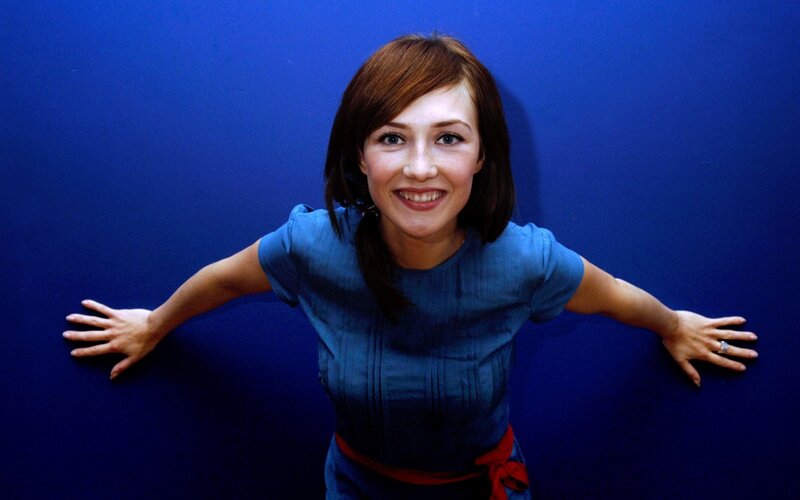 woman in blue shirt smiling
