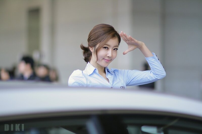 woman in blue shirt waving