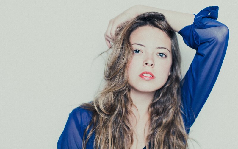 woman in blue shirt with long hair