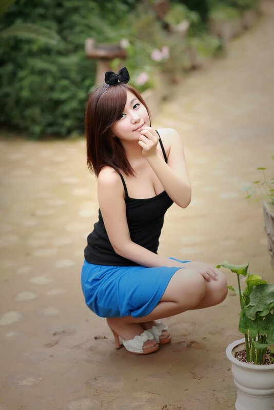 Woman in blue skirt crouching