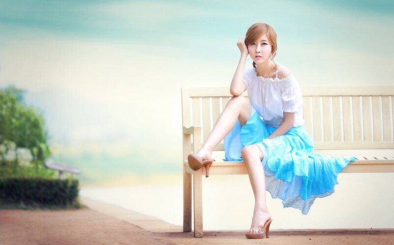 Woman in blue skirt on bench