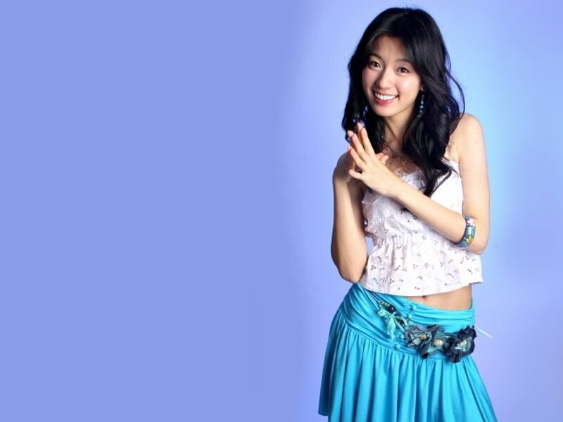 woman in blue skirt smiling