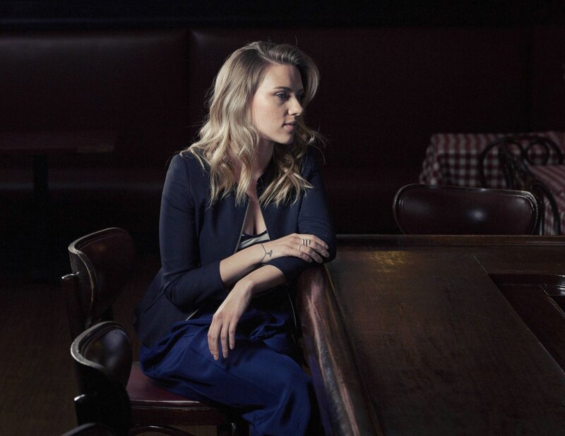 woman in blue suit sitting