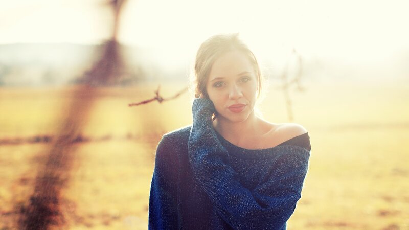 woman in blue sweater at sunset