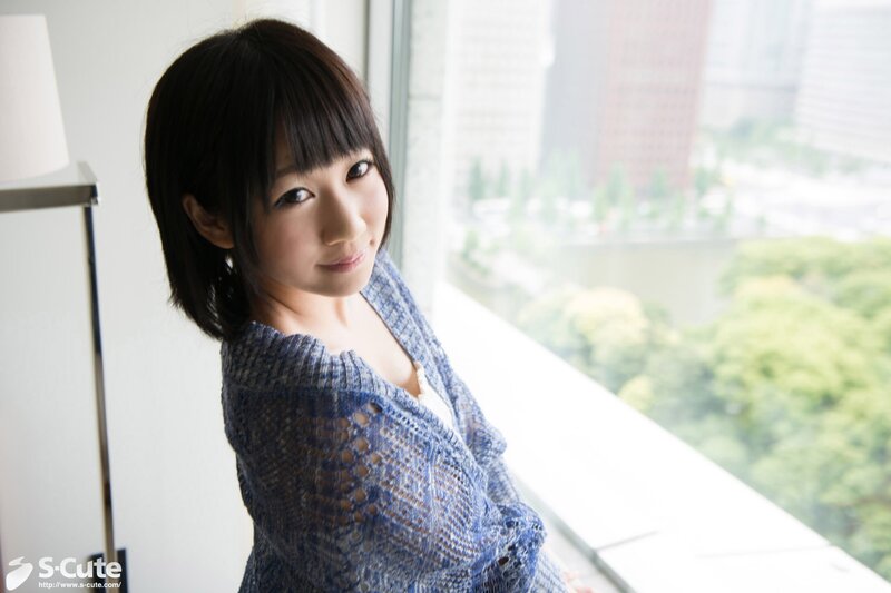 woman in blue sweater by window