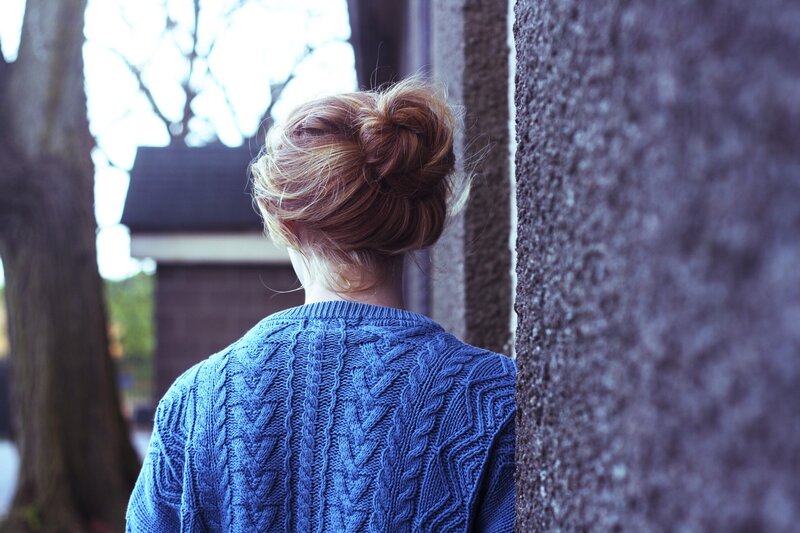 woman in blue sweater from behind