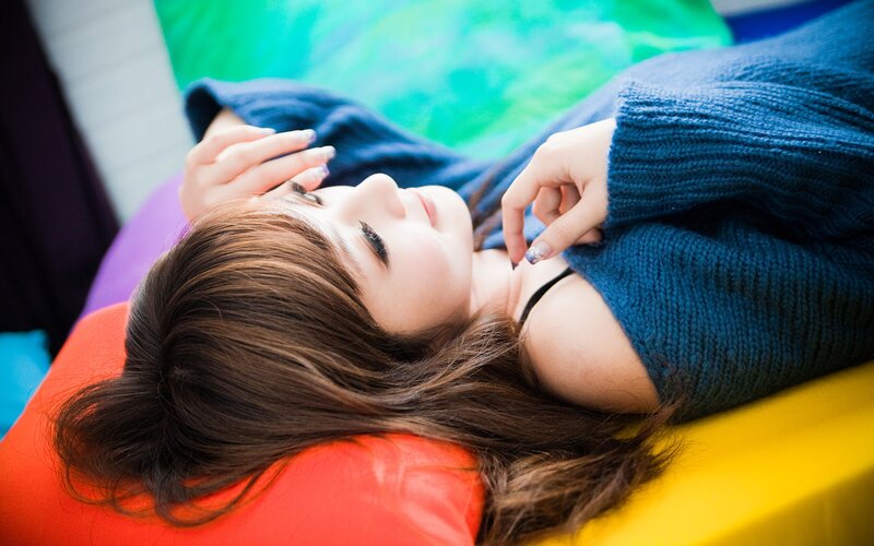woman in blue sweater lying down