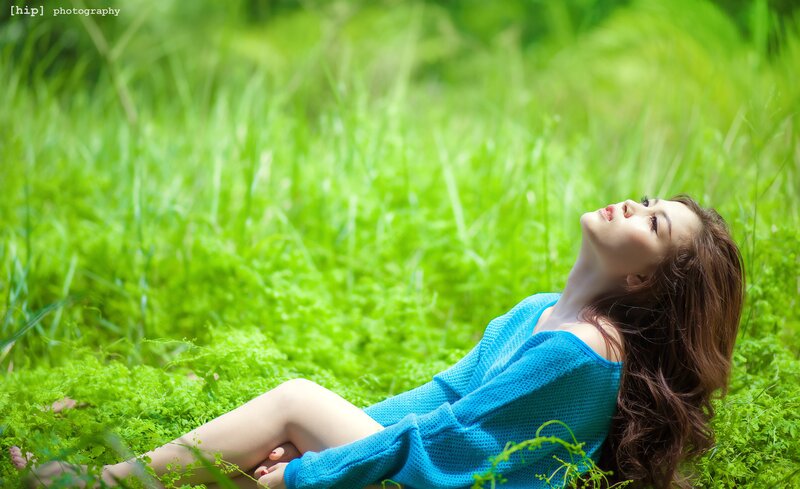 woman in blue sweater on grass