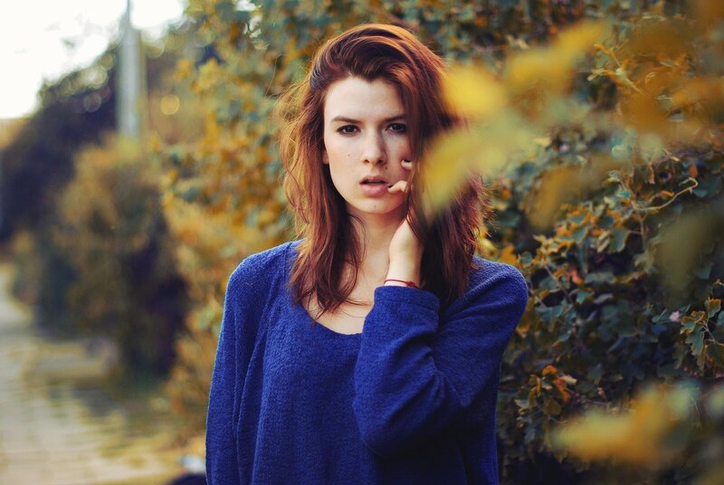 woman in blue sweater outdoors