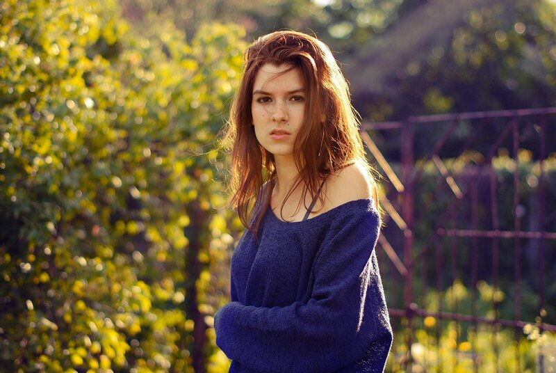 woman in blue sweater outdoors