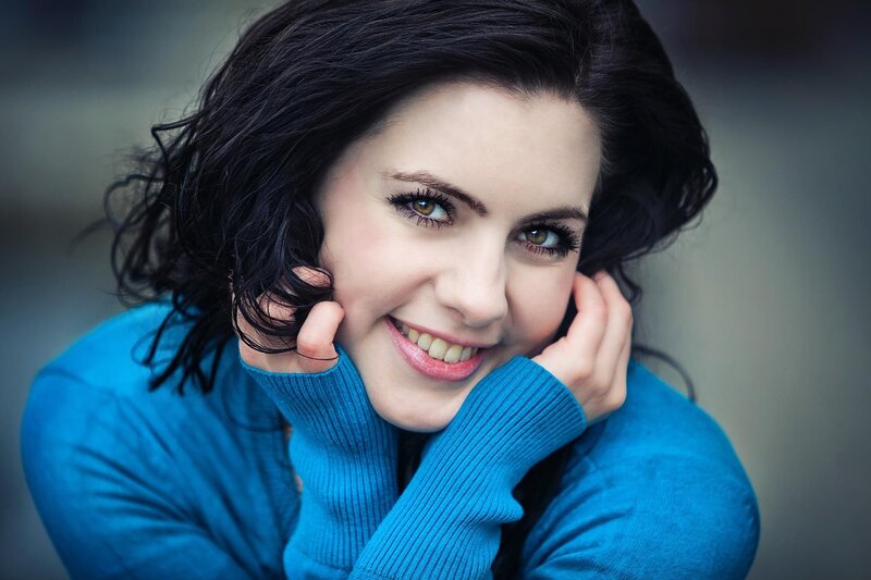 woman in blue sweater smiling