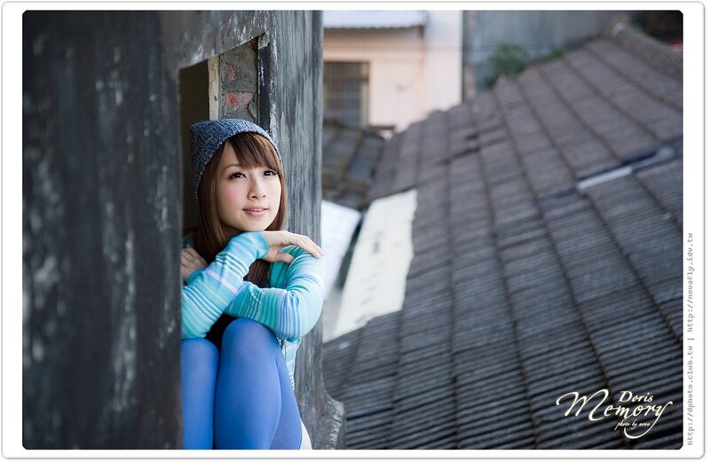 woman in blue tights by window