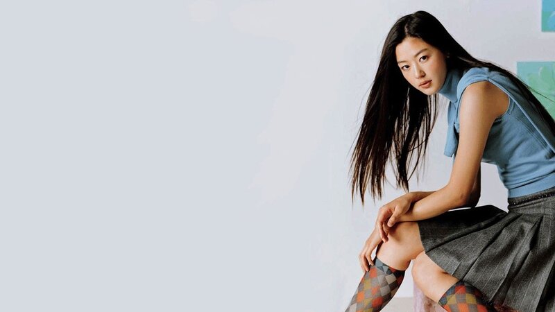woman in blue top and plaid socks
