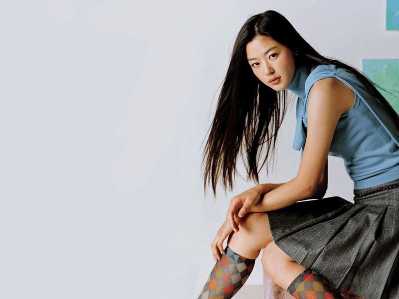 woman in blue top and plaid socks