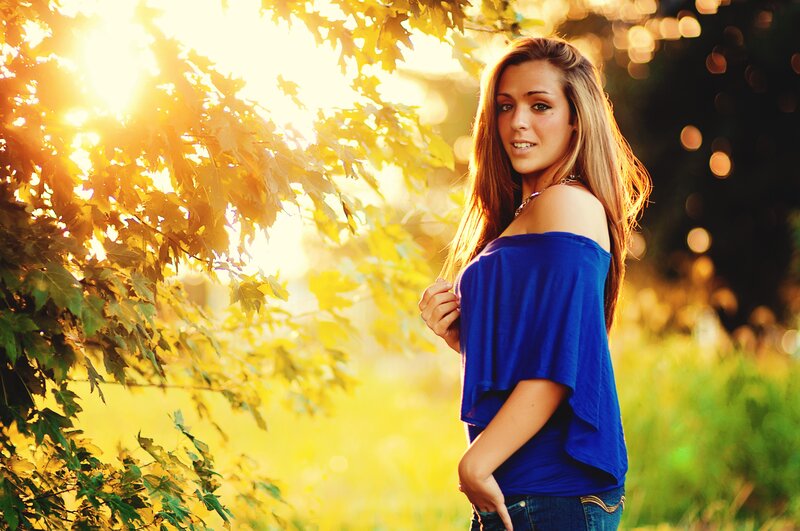 woman in blue top at sunset