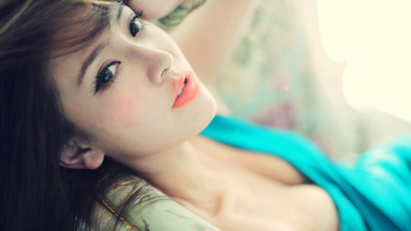 woman in blue top lying down