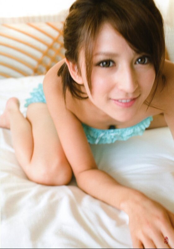 woman in blue top lying on bed