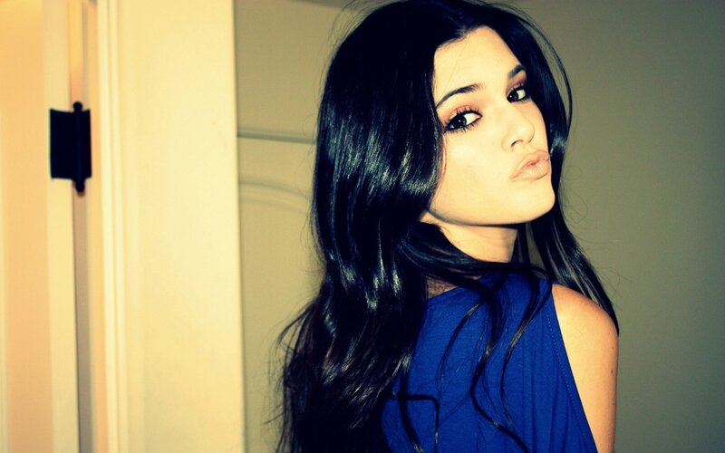 woman in blue top posing