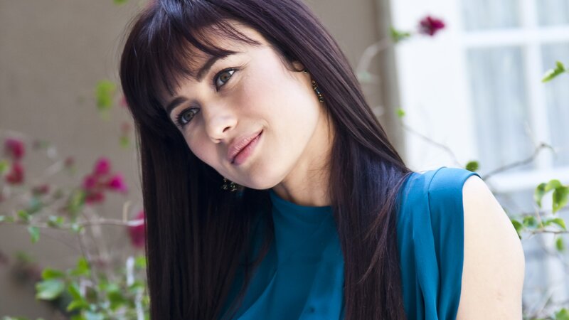 woman in blue top smiling