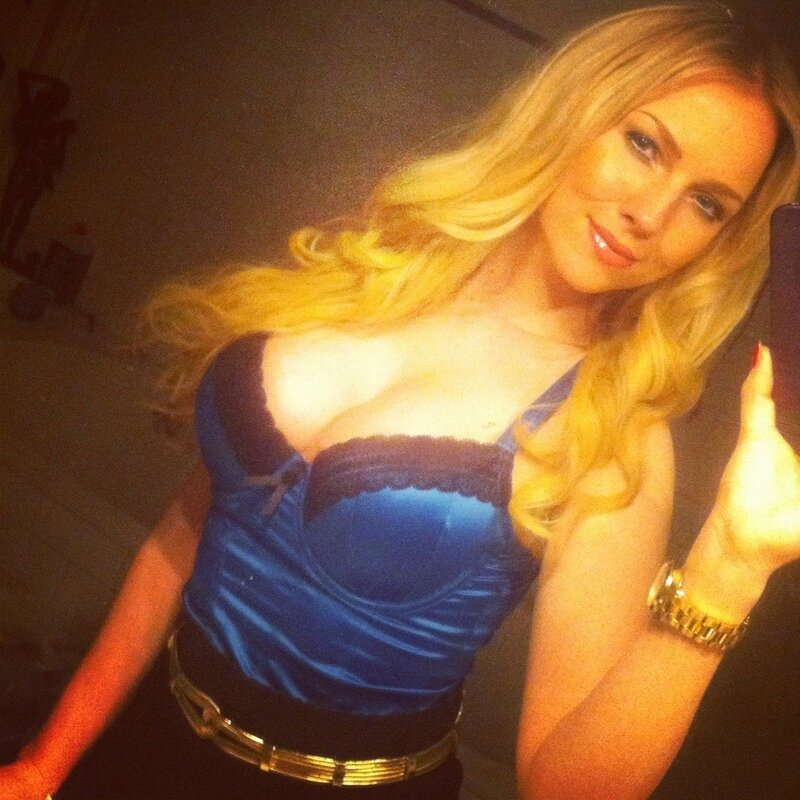 woman in blue top taking selfie