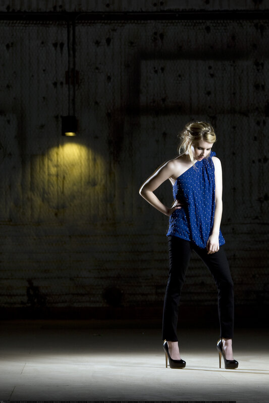 woman in blue top under spotlight