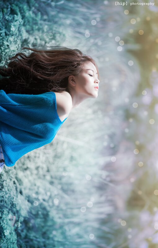 woman in blue top underwater