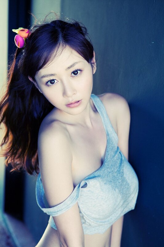 woman in blue top with flower