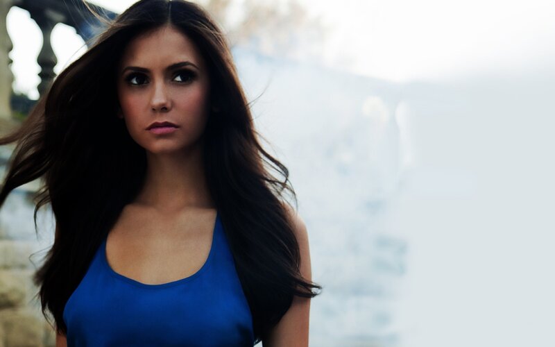 woman in blue top with long hair