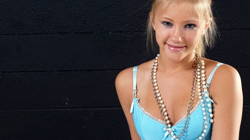 woman in blue top with pearls