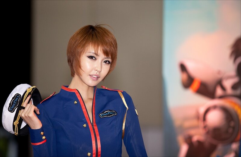 woman in blue uniform holding hat